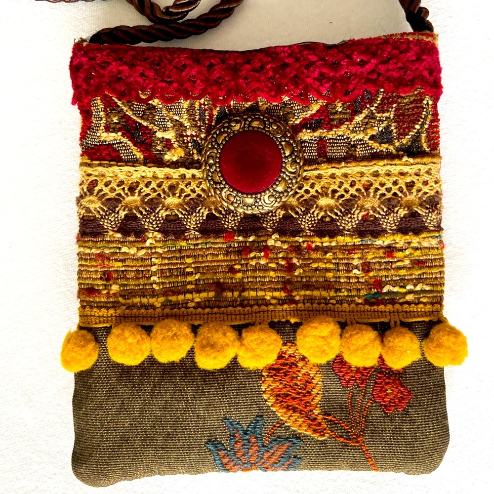 Handcrafted assorted fabric & trim crossbody bag.